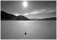 Sun and sliding rock on the Racetrack, mid-day. Death Valley National Park, California, USA. (black and white)