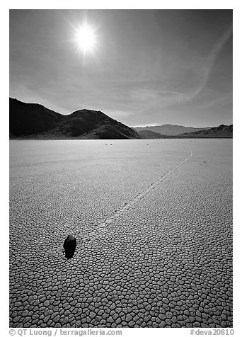 Tracks and moving rock on the Racetrack, mid-day. Death Valley National Park (black and white)