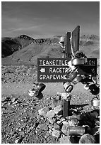Teakettle Junction sign, adorned with teakettles. Death Valley National Park, California, USA. (black and white)