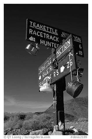 Tea kettle Junction sign, adorned with tea kettles. Death Valley National Park (black and white)