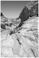Hikers in narrows, Mosaic canyon. Death Valley National Park, California, USA. (black and white)