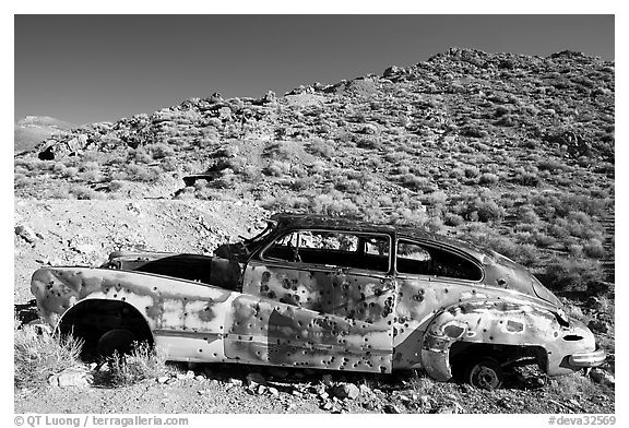 Car with bullet holes near Aguereberry camp, afternoon. Death Valley National Park (black and white)
