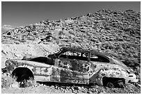 Car with bullet holes near Aguereberry camp, afternoon. Death Valley National Park, California, USA. (black and white)