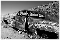 Car with bullet holes near Aguereberry camp, afternoon. Death Valley National Park ( black and white)