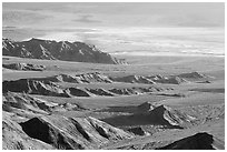 Eroded hills and salt pan from Aguereberry point, early morning. Death Valley National Park, California, USA. (black and white)