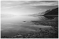 Flooded Badwater basin and Black mountain reflections, early morning. Death Valley National Park ( black and white)