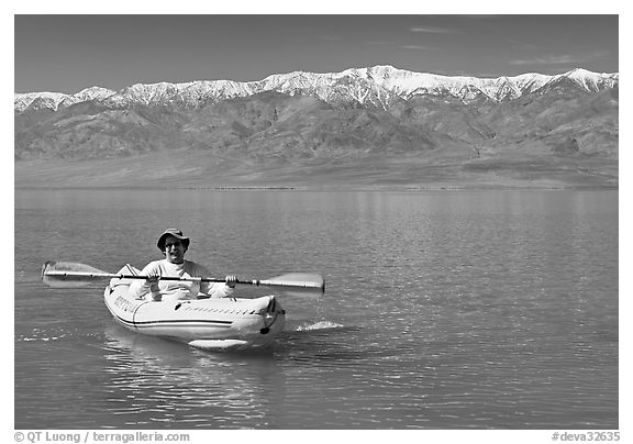 Kayaker padding ephemeral Manly Lake. Death Valley National Park, California, USA.