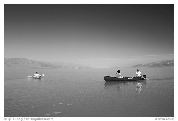 Canoists and kayaker on the flooded floor. Death Valley National Park, California, USA.