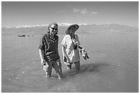 Women wading in the knee-deep seasonal lake. Death Valley National Park ( black and white)