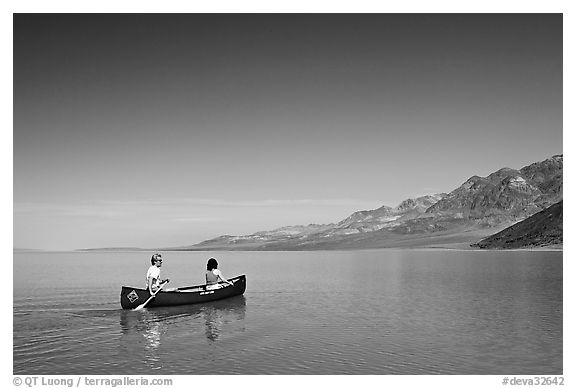 Canoeing on the ephemerald Manly Lake with Black Mountains in the background. Death Valley National Park, California, USA.