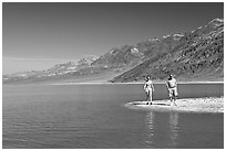 Couple on the shores of Manly Lake. Death Valley National Park, California, USA. (black and white)