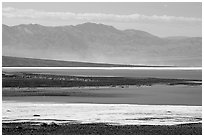 Salt Flats on Valley floor and Owlshead Mountains, early morning. Death Valley National Park ( black and white)