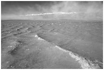 Extremely rare waves on mud-colored Manly Lake, early morning. Death Valley National Park ( black and white)