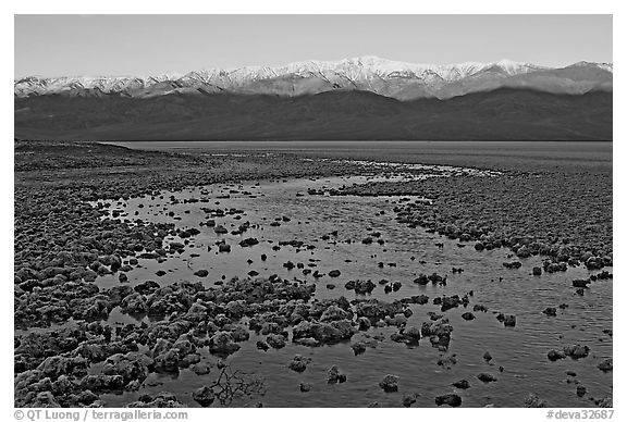 Salt pool and sunrise over the Panamints. Death Valley National Park, California, USA.