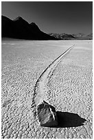 Sailing rock and travel groove on the Racetrack. Death Valley National Park, California, USA. (black and white)