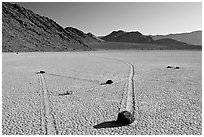 Moving rocks and non-linear tracks, the Racetrack. Death Valley National Park, California, USA. (black and white)