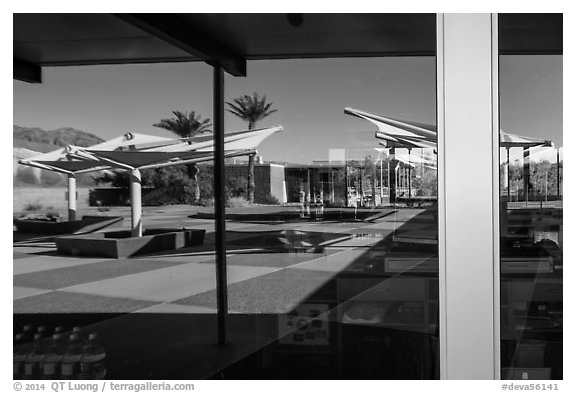 Patio, oasis and mountains, Furnace Creek Visitor Center window reflexion. Death Valley National Park (black and white)