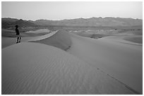 Park visitor looking, Mesquite Sand Dunes. Death Valley National Park ( black and white)