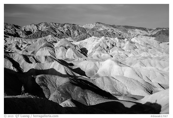 Visitor looking, Twenty Mule Team Canyon. Death Valley National Park (black and white)