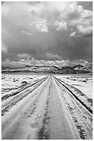 Straight road through Salt Pan. Death Valley National Park ( black and white)