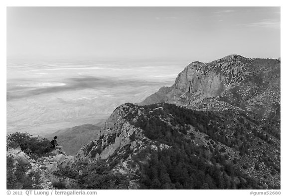 Hiker surveying view over mountains and plains. Guadalupe Mountains National Park (black and white)
