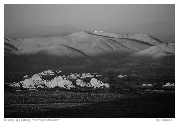 White Tanks rocks and Pinto Mountains at sunset. Joshua Tree National Park (black and white)