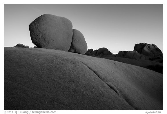 Twin boulders and crack at sunrise. Joshua Tree National Park (black and white)