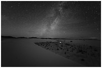 Backcountry camping area with lit tent at night. White Sands National Park ( black and white)