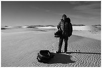 Photographer holding large format camera. White Sands National Park ( black and white)