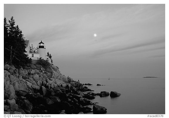 Bass Harbor lighthouse on rocky coast, sunset. Acadia National Park, Maine, USA.