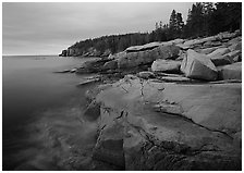 Granite slabs and Otter Point at sunrise. Acadia National Park, Maine, USA. (black and white)