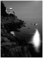 Bass Harbor lighthouse by night with reflections of moon and lighthouse light. Acadia National Park ( black and white)