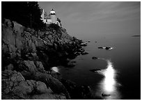 Bass Harbor lighthouse by night with moon reflection in ocean. Acadia National Park, Maine, USA. (black and white)