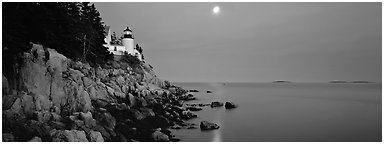 Dusk seascape with lightouse, moon, and reflection. Acadia National Park (Panoramic black and white)