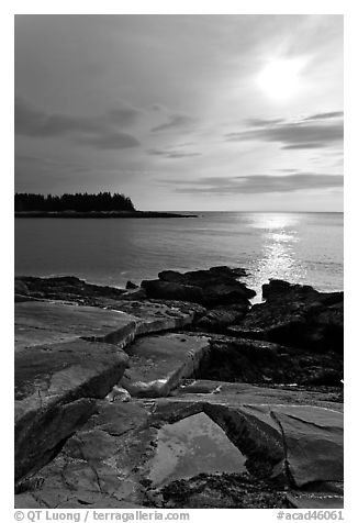 Rock slabs and sun over ocean, Schoodic Peninsula. Acadia National Park, Maine, USA.