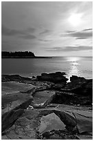 Rock slabs and sun over ocean, Schoodic Peninsula. Acadia National Park, Maine, USA. (black and white)