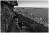 Hikers on ledge with handrails, Precipice Trail. Acadia National Park ( black and white)