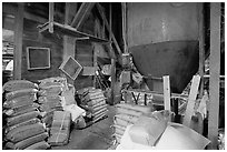 Grain distributor and bags of  seeds in Wilson feed mill. Cuyahoga Valley National Park, Ohio, USA. (black and white)