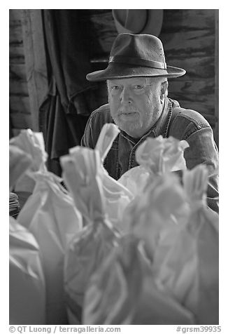 Miller sitting behind bags of cornmeal, North Carolina. Great Smoky Mountains National Park, USA.