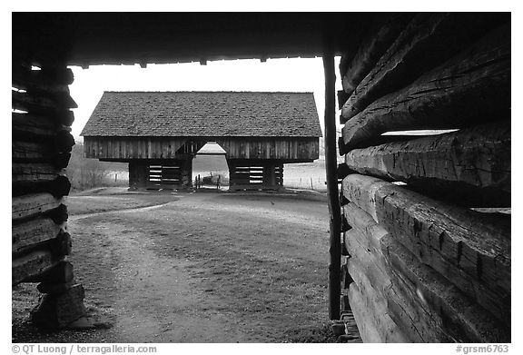 Cantilever barn framed by doorway, Cades Cove, Tennessee. Great Smoky Mountains National Park (black and white)