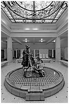 Statue of Desoto receiving gift from Caddo Indian maiden in mens bath hall. Hot Springs National Park ( black and white)