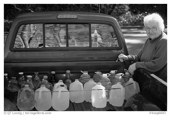 Resident stocks up on natural spring water. Hot Springs National Park (black and white)