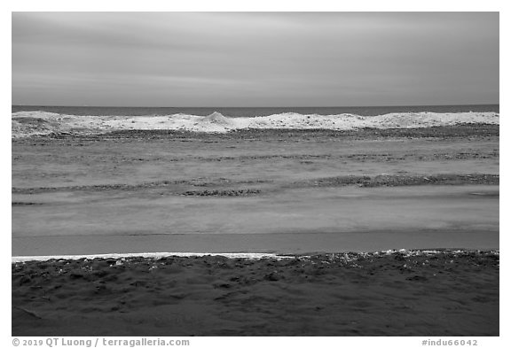 Beach in winter with ice. Indiana Dunes National Park (black and white)