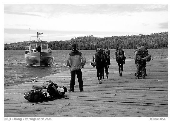 Backpackers waiting for pick-up by the ferry at Windego. Isle Royale National Park, Michigan, USA.