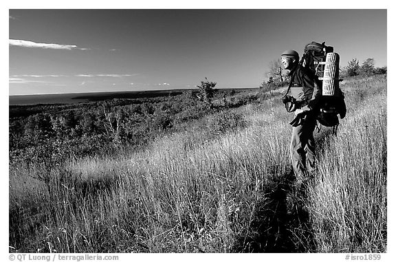 Backpacker pausing on Greenstone ridge trail. Isle Royale National Park (black and white)