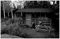 Backpacker sitting in shelter at Chippewa harbor. Isle Royale National Park, Michigan, USA. (black and white)