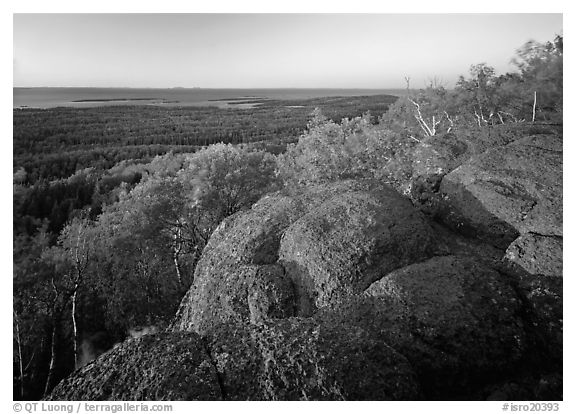 Mount Franklin granite outcrop and distant Lake Superior at sunset. Isle Royale National Park, Michigan, USA.