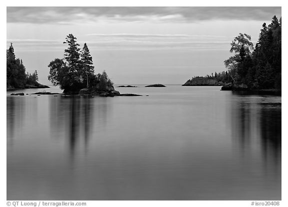Tree-covered islet and smooth waters, Chippewa Harbor. Isle Royale National Park (black and white)