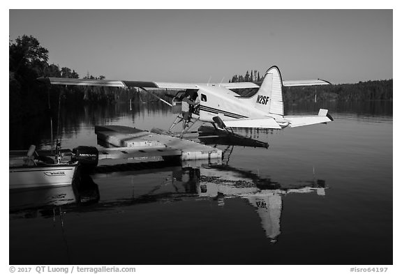 Pilot opening door at floatplane dock. Isle Royale National Park (black and white)