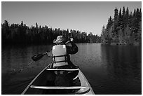 Canoist paddling seen from back, Tobin Harbor. Isle Royale National Park ( black and white)